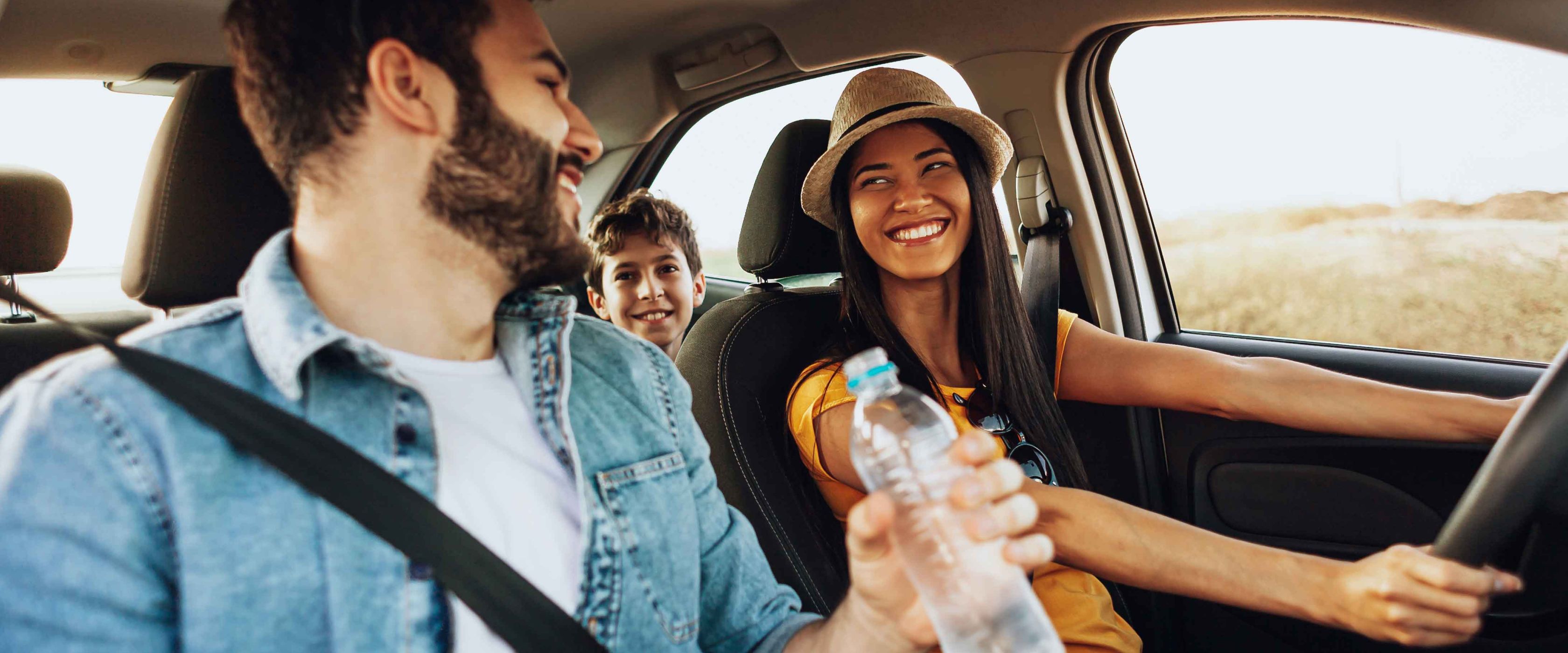 Family driving and smiling