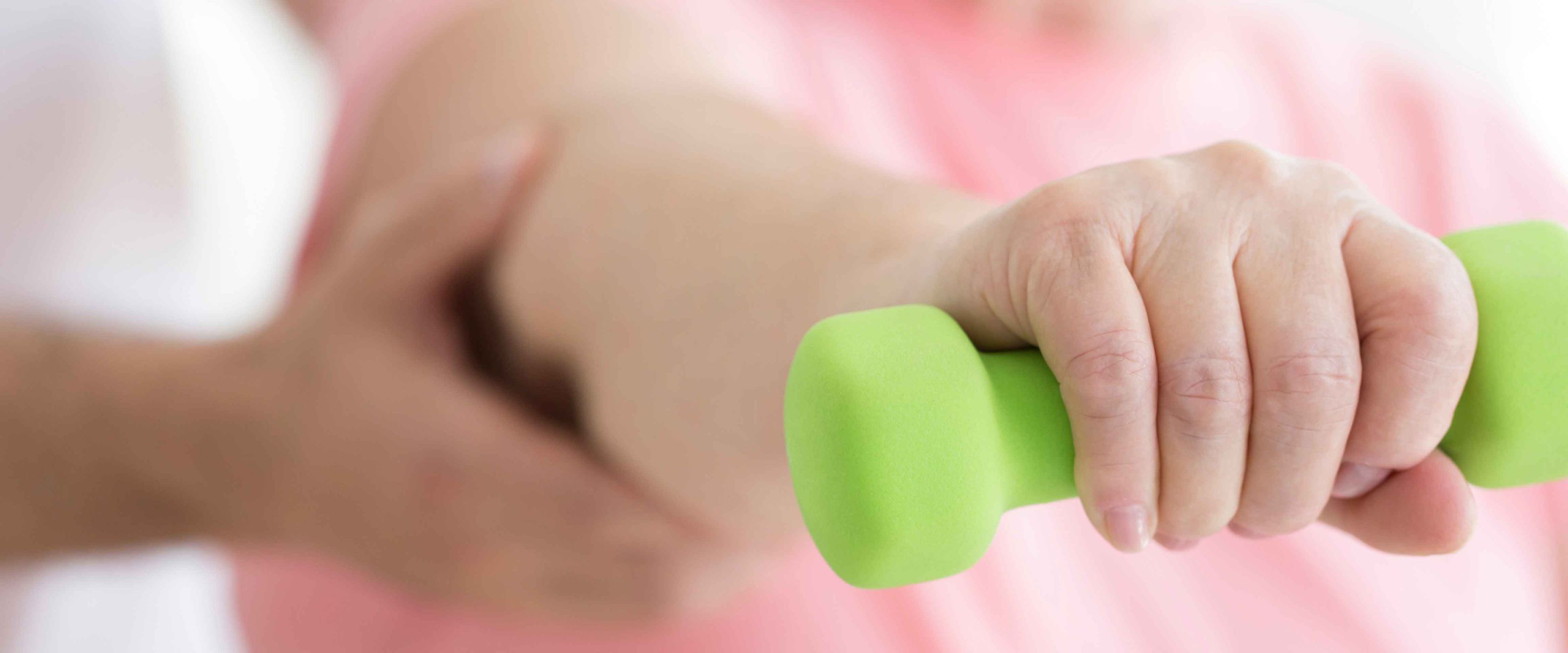 Woman holding weight during physical therapy