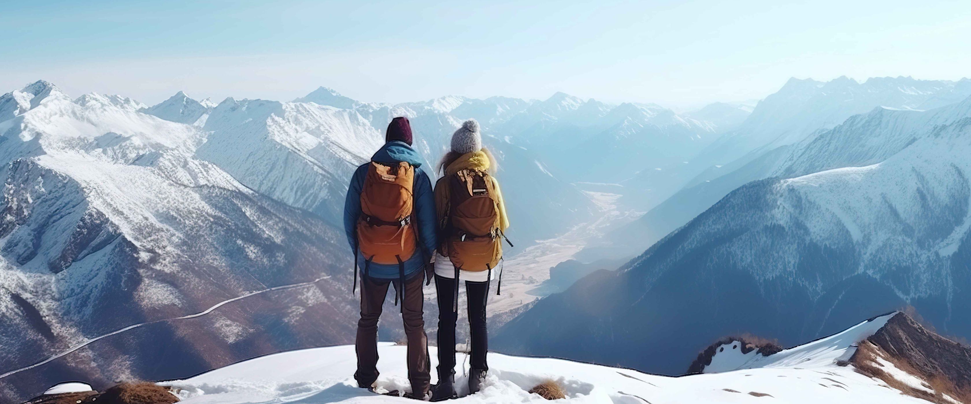 Two people standing on snow capped mountain