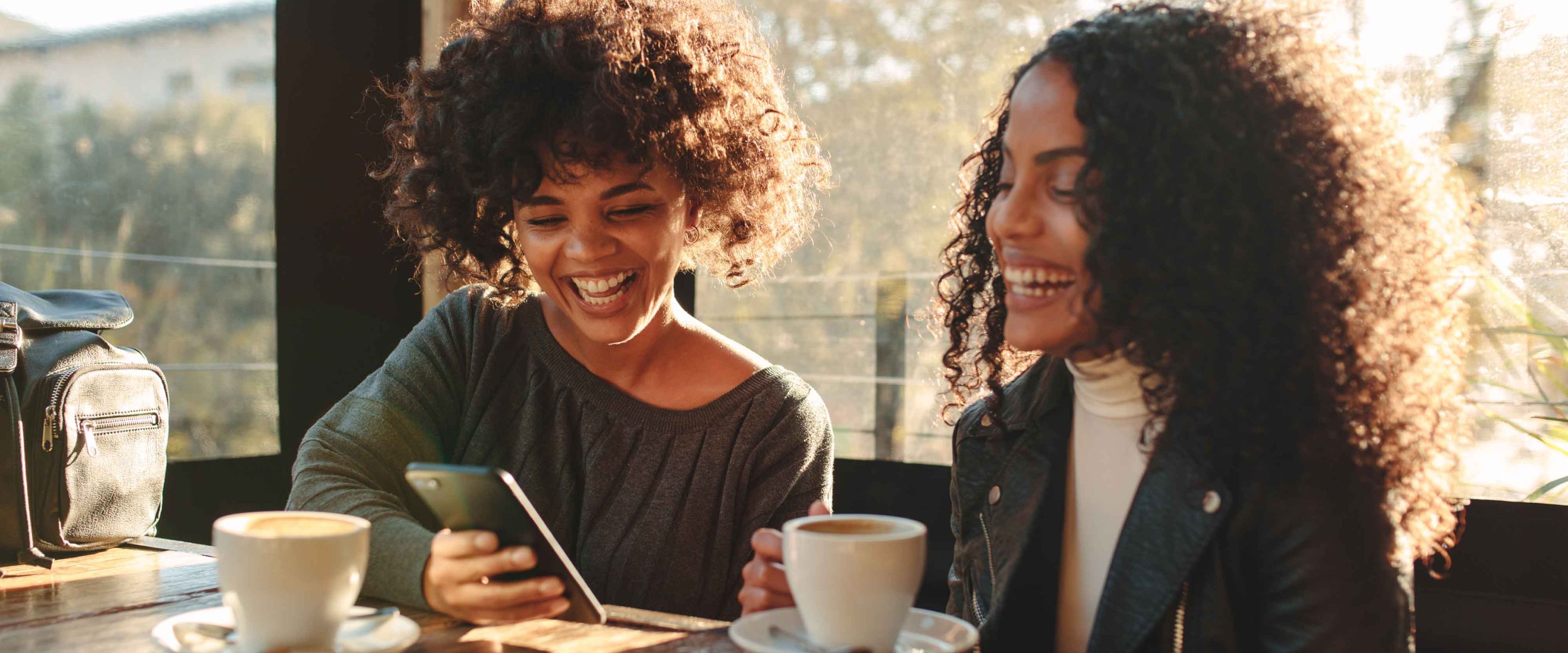 Two women conversing over coffee