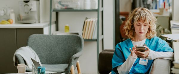 Nurse reading apps on phone