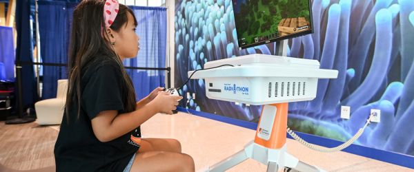 Child at pediatric hospital enjoying a GO Kart game