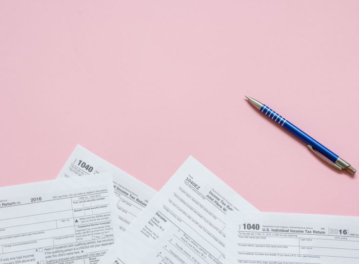 Tax papers on a pink background