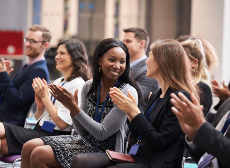 People clapping at a conference
