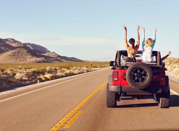 Two woman in a jeep with the top down