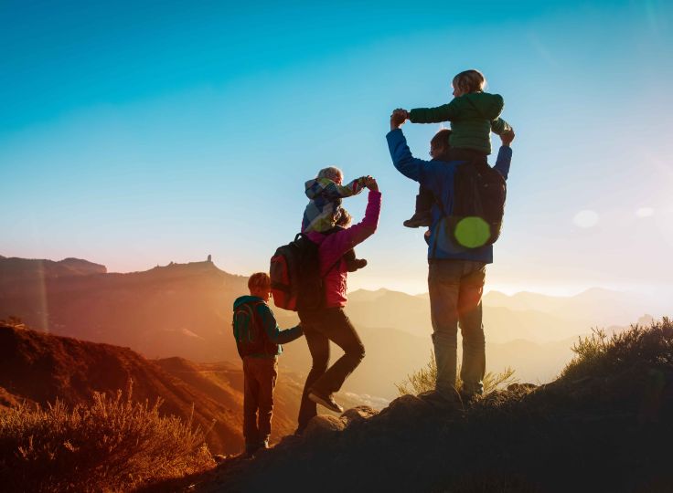 Mother and Father hiking with their kids