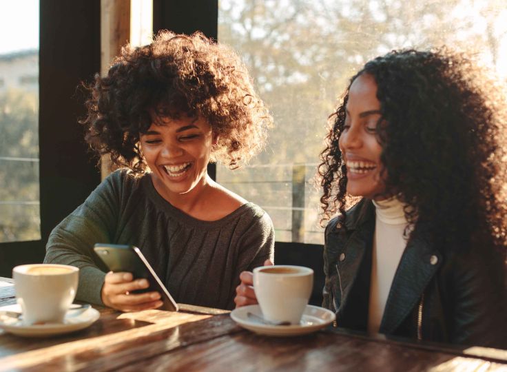 Two women conversing over coffee