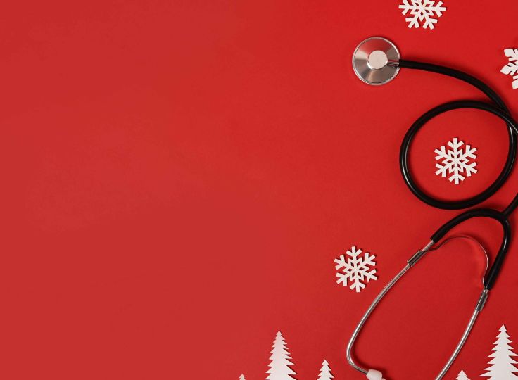 Stethoscope on red background with snowflakes