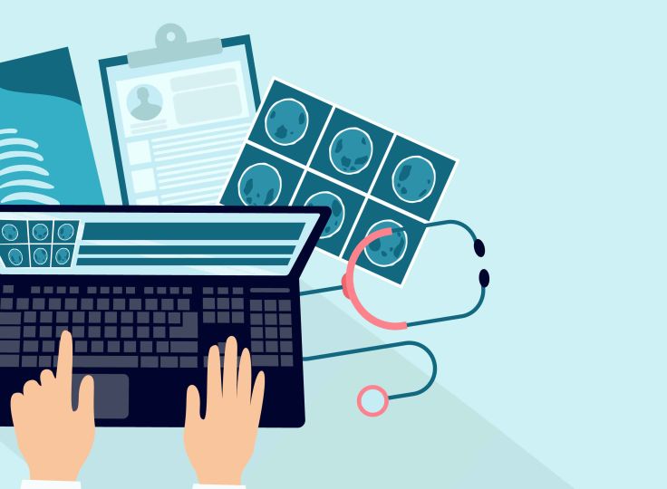 Nurse typing on computer with Xrays