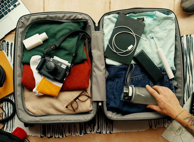 Person packing a suitcase