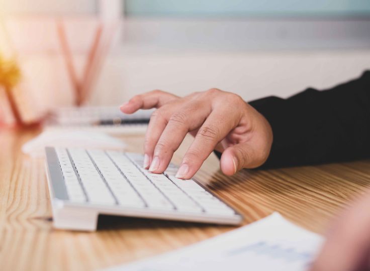 Person typing on keyboard