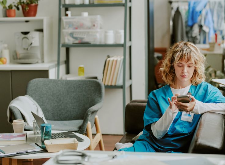 Nurse reading apps on phone