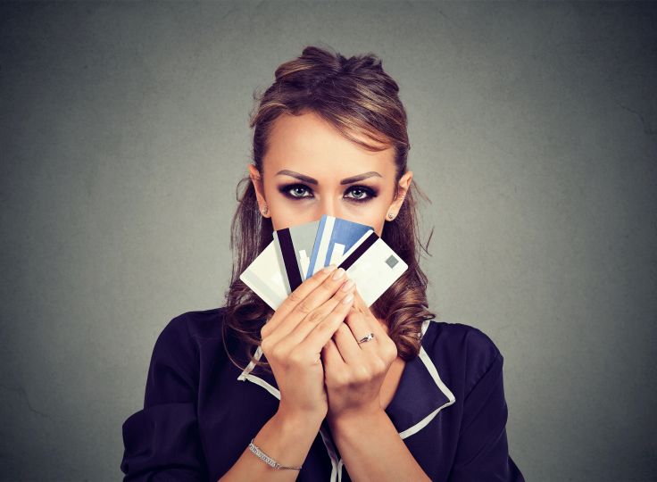 female holding a selection of credit cards