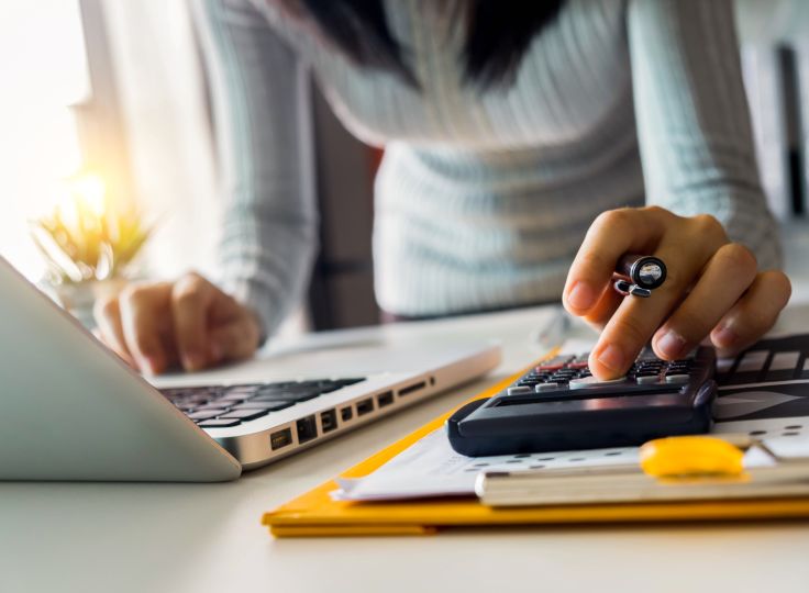 female calculating her taxes