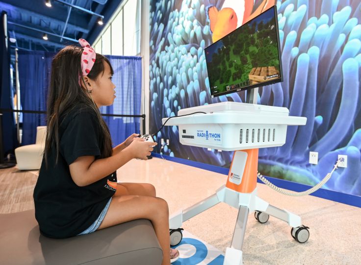 Child at pediatric hospital enjoying a GO Kart game