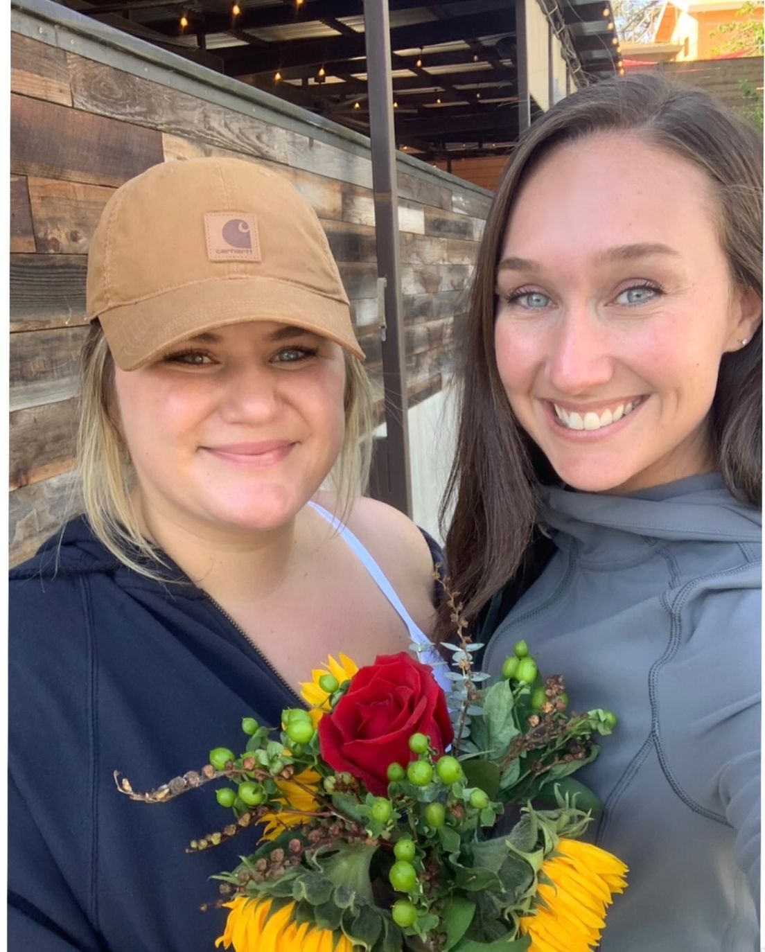Two women holding flowers