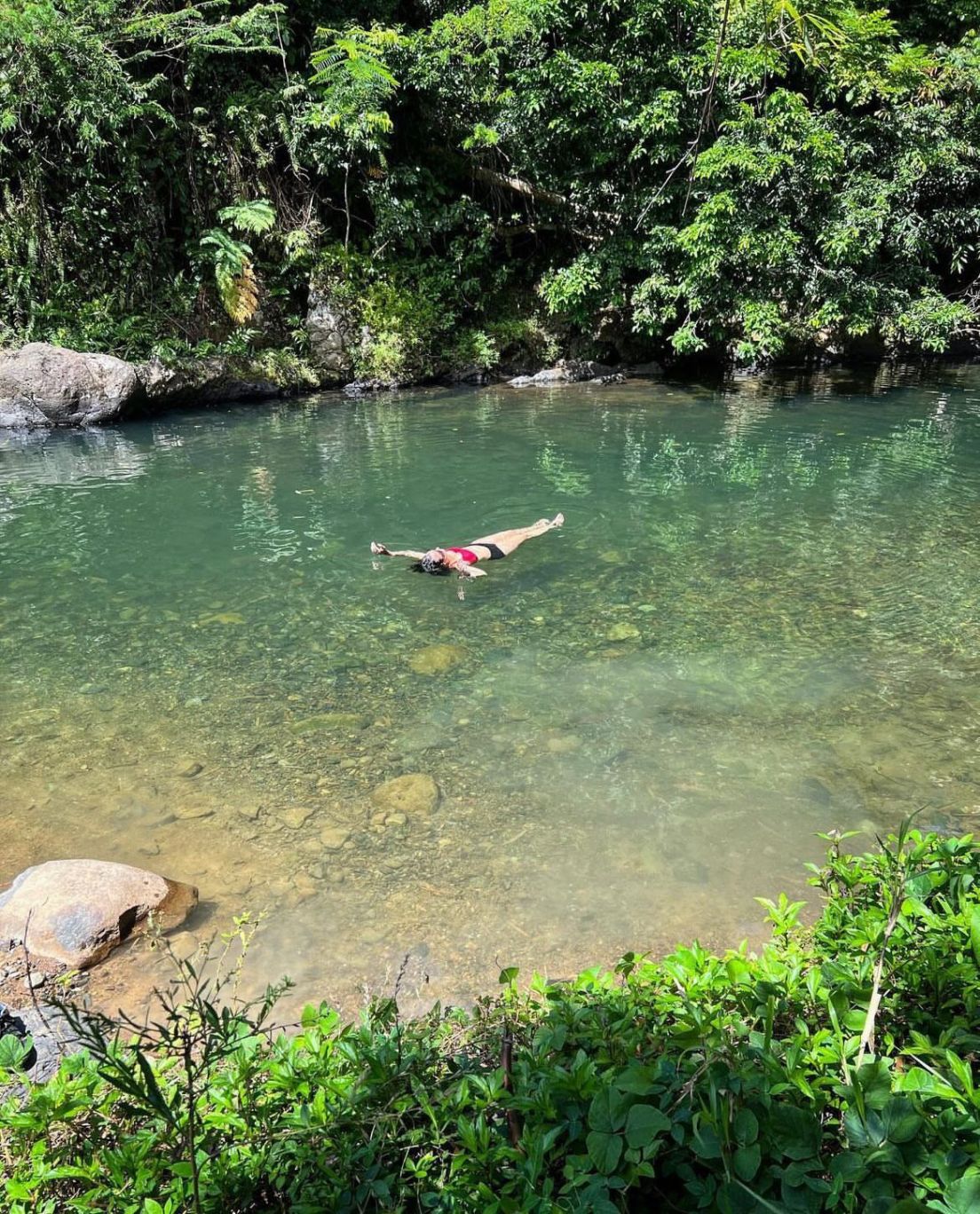 Woman swimming in a body of water