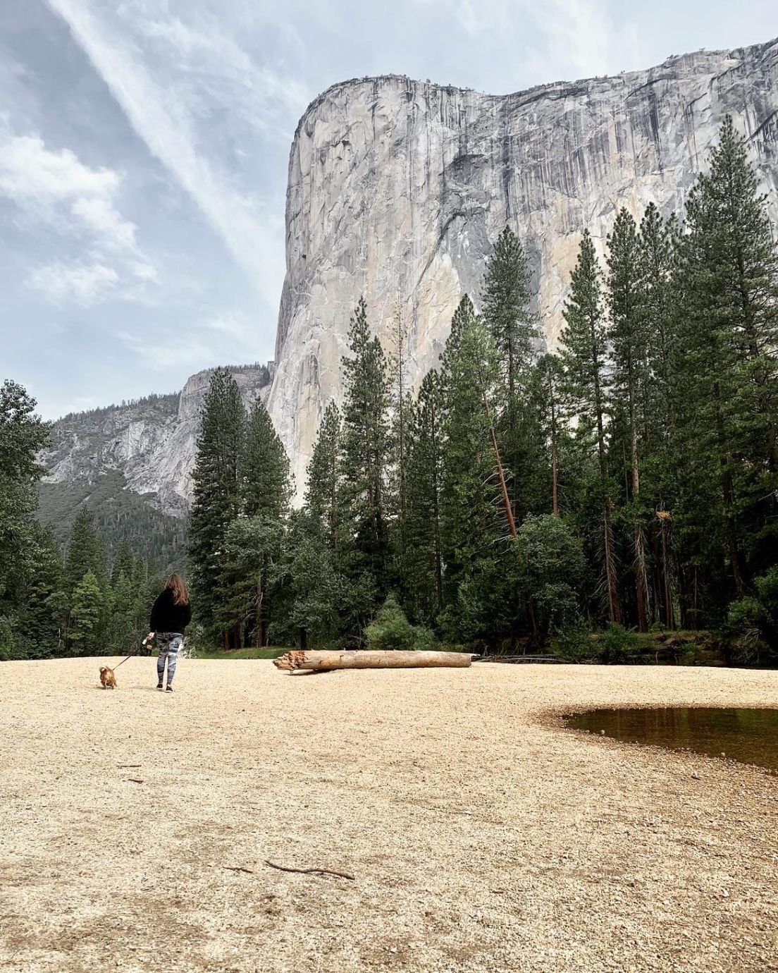 Person standing below rock formation