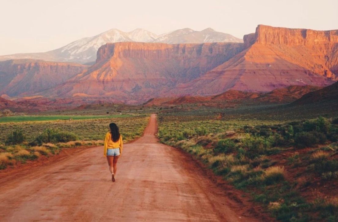 Woman standing on dirt road