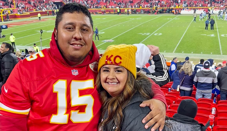 Man and woman at football game smiling