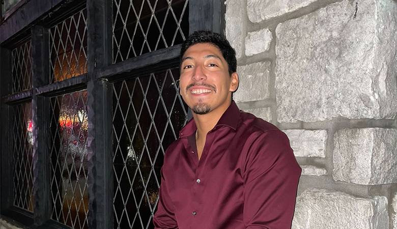 Man standing in front of stone wall