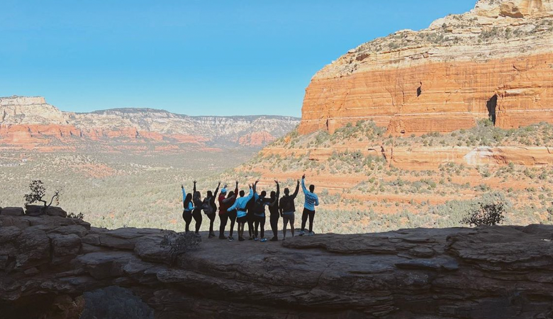 Group of people standing near rock formation