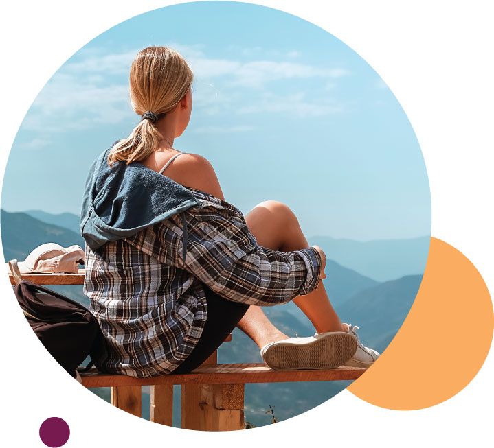 Woman sitting overlooking mountains