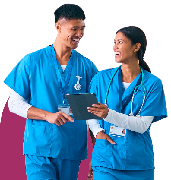 Two clinicians smile as they review patient notes on a tablet