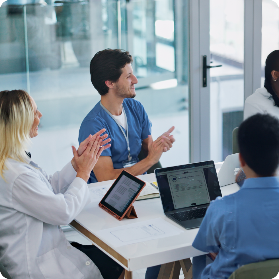 Clinicians applaud during a meeting