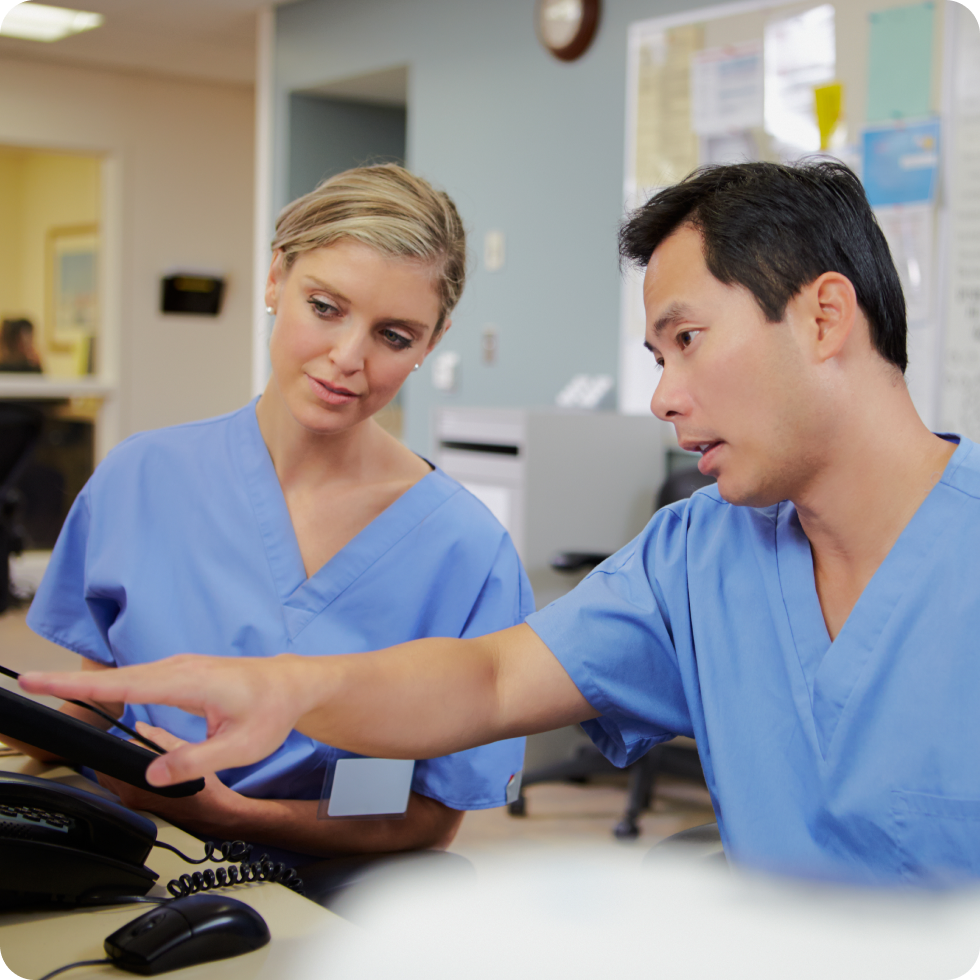 Two clinicians study a monitor