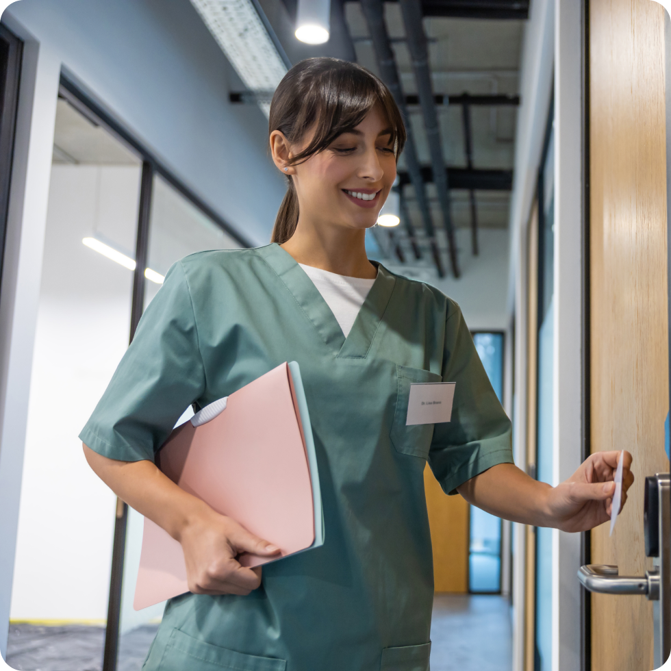 A clinician uses a key card to access a secure location