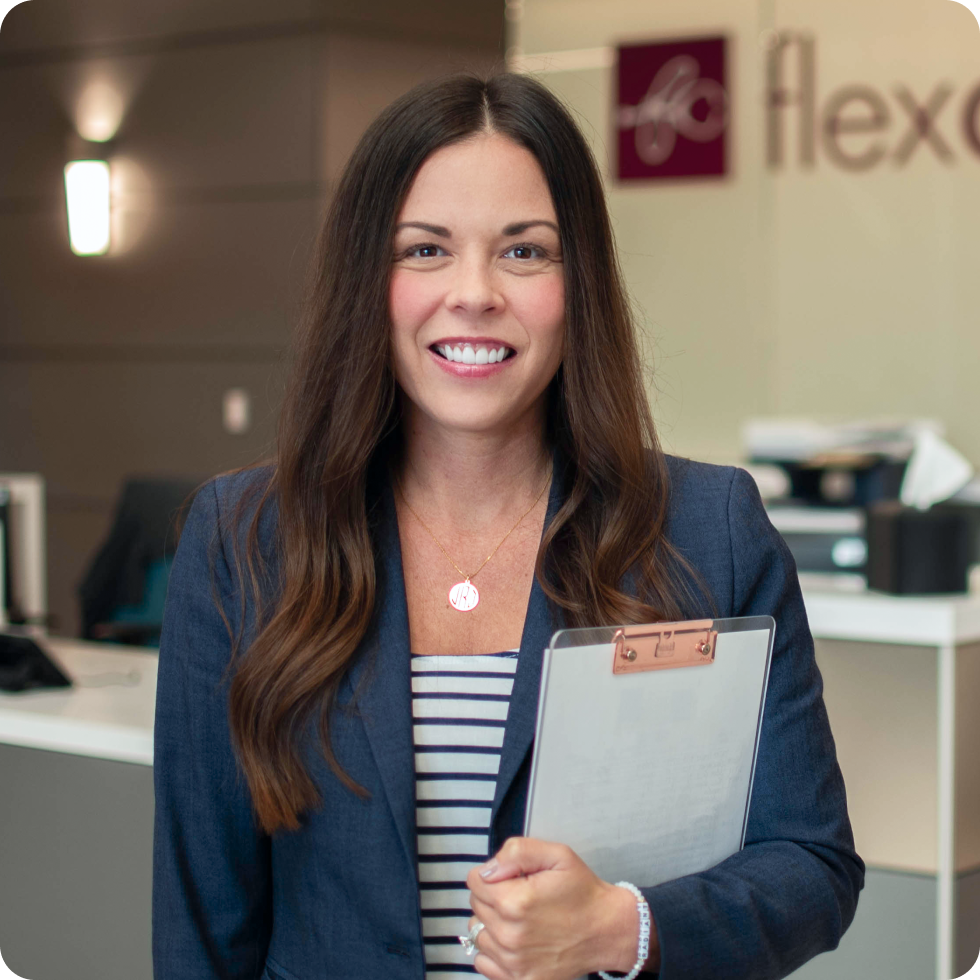 A woman holding a clipboard in the FlexCare office