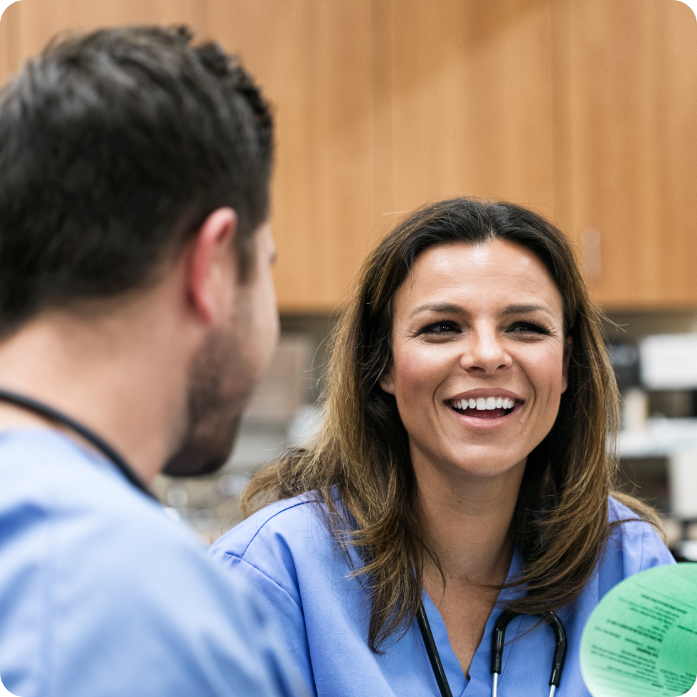 A group of clinicians smiling and conversing