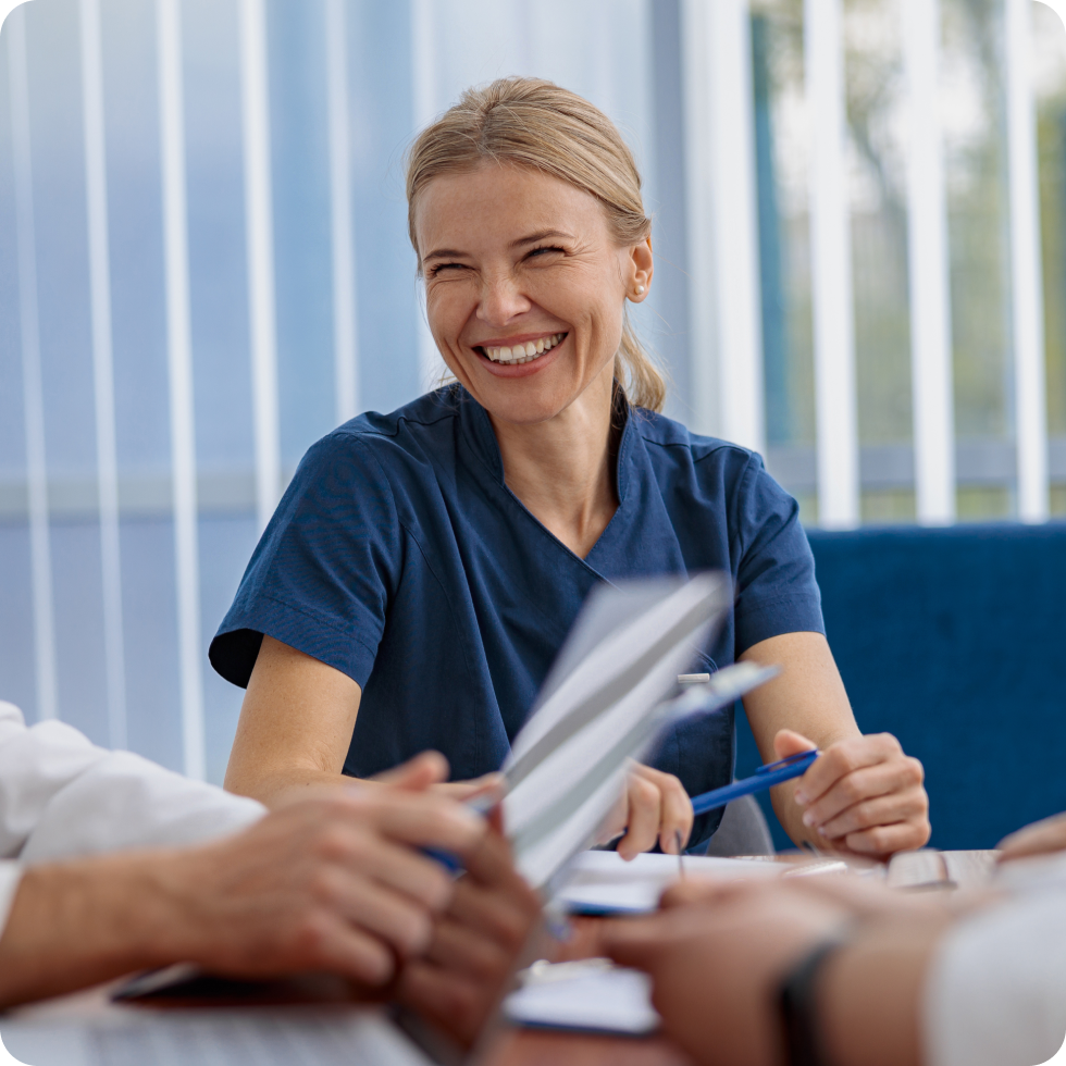 A clinician smiles after signing a new travel contract