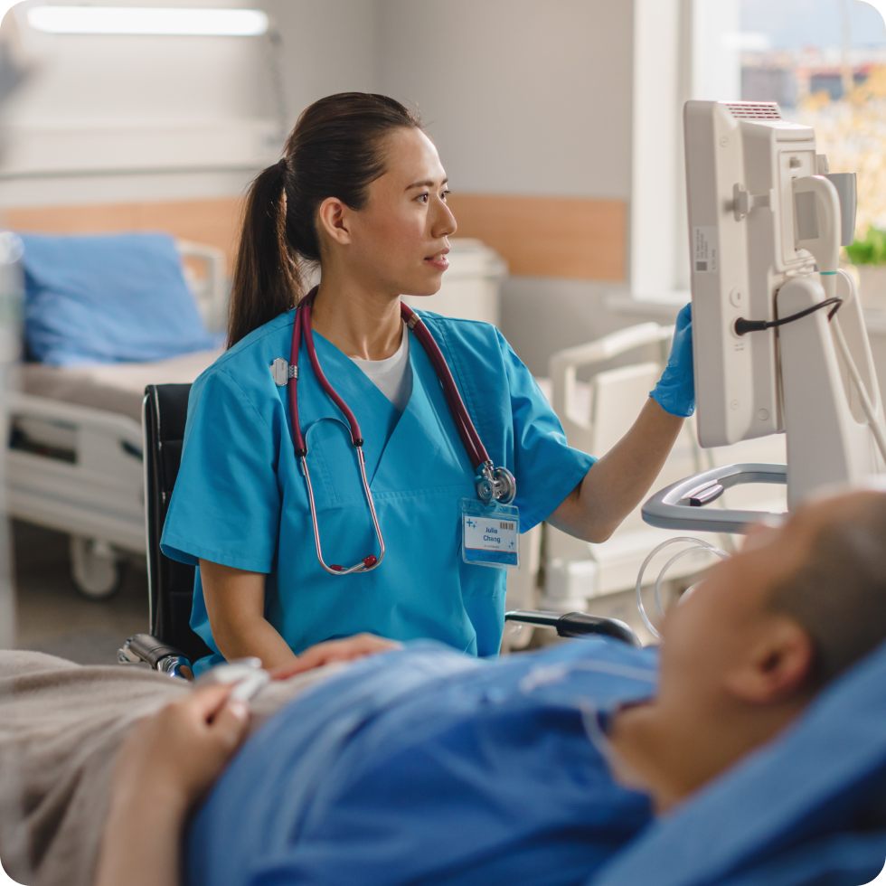A Clinician checks a patient's monitor