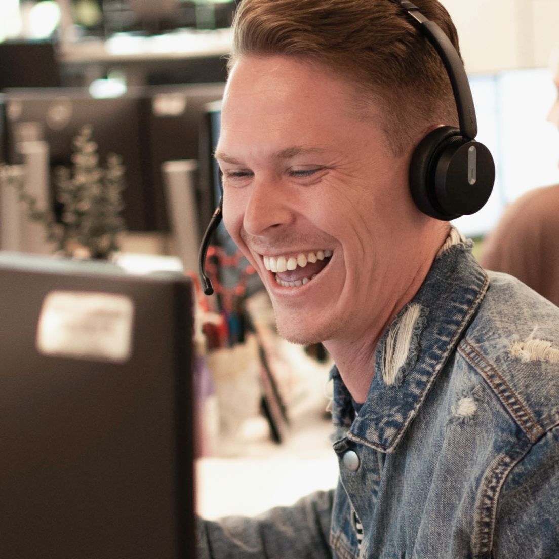 A FlexCare recruiter smiling while speaking to a clinician