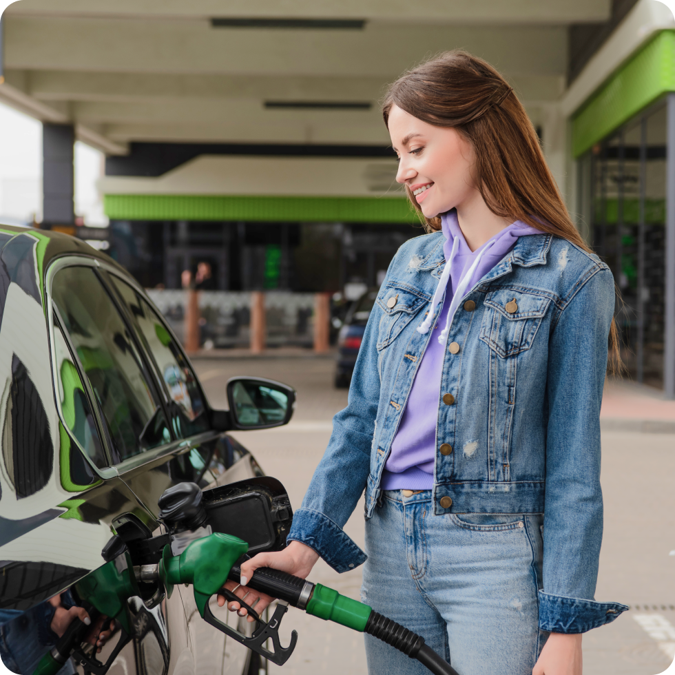 A clinician fills their car with gas