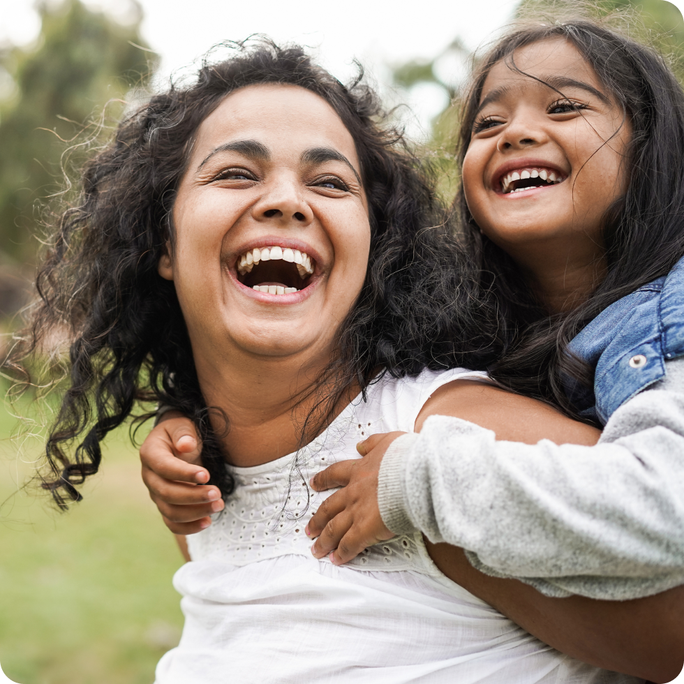 A clinician and her daughter laugh and play