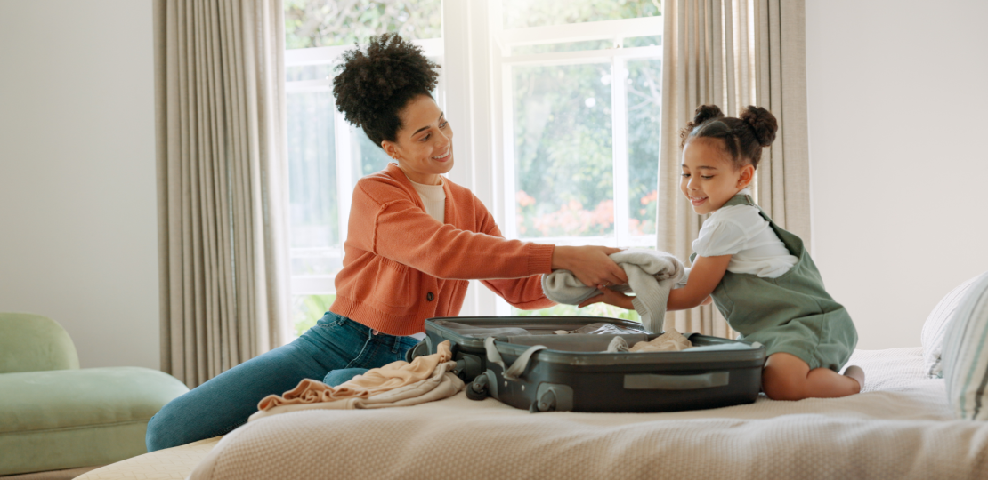 A clinician packing a bag while her daughter helps