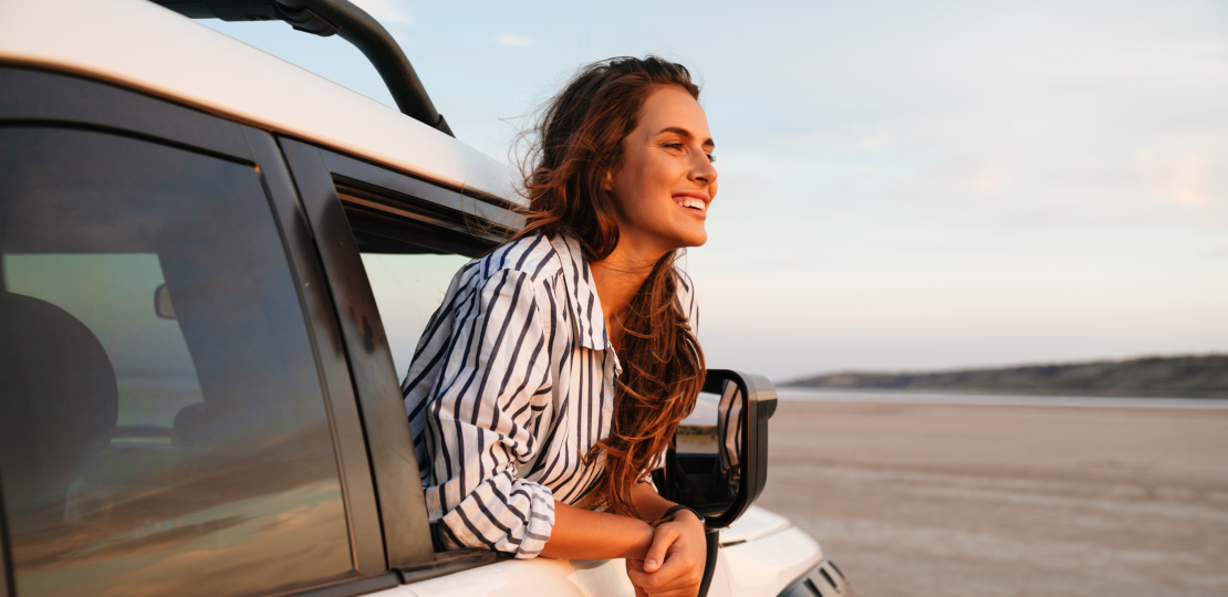 A clinician enjoys the view outside her car window