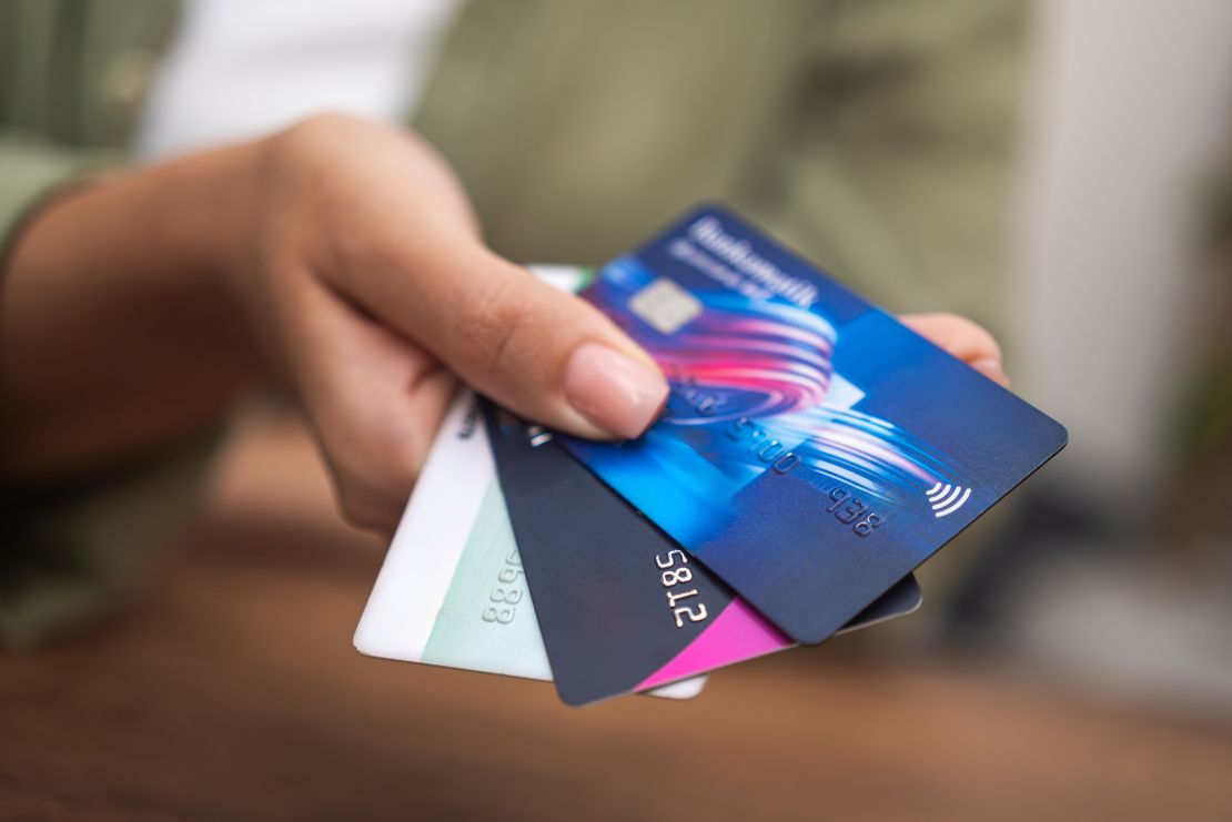 female hand offering a choice of credit cards