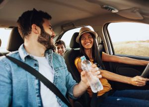 Family driving and smiling