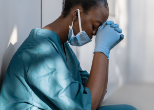 A clinician takes a moment to think