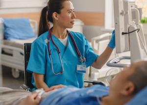 A Clinician checks a patient's monitor