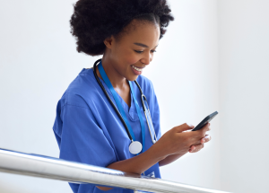 A clinician checks their mobile app for new travel nursing locations