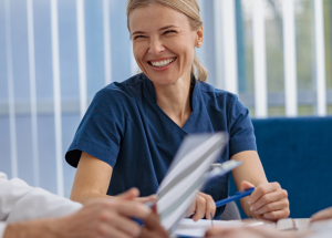 A clinician smiles after signing a new travel contract