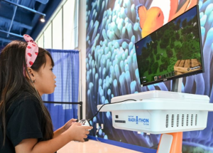 A patient enjoys playing video games on a FlexCare donated station